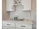 Close up of kitchen counter featuring a wine rack above and a white countertop with modern accents at 9615 Riviera Dr, Sherrills Ford, NC 28673