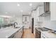 A modern kitchen showcases an island with a sink and a stainless steel appliance package at 9615 Riviera Dr, Sherrills Ford, NC 28673