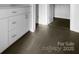 Bathroom features white cabinets and sleek tile flooring near an open doorway at 9819 Festival Way, Charlotte, NC 28215