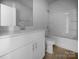 Clean, bright bathroom featuring white vanity, modern fixtures, and a tub-shower combination at 9819 Festival Way, Charlotte, NC 28215