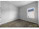 Bright bedroom features neutral carpet, a window, and freshly painted white walls at 9819 Festival Way, Charlotte, NC 28215