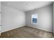 A simple, spacious bedroom with neutral carpet and ample natural light from a large window at 9819 Festival Way, Charlotte, NC 28215