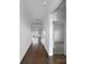 Bright hallway with hardwood floors and white walls leading to other rooms in the home at 9819 Festival Way, Charlotte, NC 28215