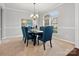 Bright dining room with an elegant chandelier fixture, large window and plenty of seating at 9823 Shearwater Nw Ave, Concord, NC 28027