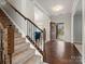 Inviting foyer featuring hardwood floors, staircase with wrought iron railing, and lots of natural light at 9823 Shearwater Nw Ave, Concord, NC 28027