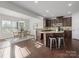 Open-concept kitchen with granite countertops, stainless steel appliances, and breakfast bar at 9823 Shearwater Nw Ave, Concord, NC 28027