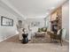 Spacious living room featuring a stone fireplace, neutral decor, and lots of natural light at 9823 Shearwater Nw Ave, Concord, NC 28027