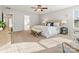 Spacious main bedroom with natural light, carpet, a ceiling fan, and ensuite bath access at 9823 Shearwater Nw Ave, Concord, NC 28027