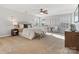 Large main bedroom with plush carpet, ceiling fan, and comfortable seating at 9823 Shearwater Nw Ave, Concord, NC 28027