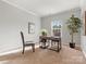 Well-lit office space with neutral walls, carpet, and a modern desk near a window at 9823 Shearwater Nw Ave, Concord, NC 28027