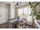 Bright dining room features a large window, table with seating for four, and elegant curtains at 10390 Tintinhull Dr, Indian Land, SC 29707