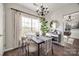 Stylish dining room featuring a window, table with four chairs, and sideboard with wine rack at 10390 Tintinhull Dr, Indian Land, SC 29707