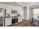 Well-lit kitchen with stainless steel appliances, granite counters, and direct access to the dining area at 10390 Tintinhull Dr, Indian Land, SC 29707