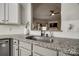 Kitchen with granite countertops, stainless steel sink and view to the living room at 10390 Tintinhull Dr, Indian Land, SC 29707