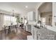 Kitchen view to dining area with stainless dishwasher, sink, and granite countertops at 10390 Tintinhull Dr, Indian Land, SC 29707