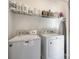 Well-organized laundry room with washer, dryer, shelving, ironing board, and ample storage space at 10390 Tintinhull Dr, Indian Land, SC 29707