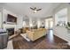 Cozy living room featuring hardwood floors, neutral paint colors, and a fireplace at 10390 Tintinhull Dr, Indian Land, SC 29707