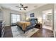 A beautiful main bedroom with wood floors, ensuite bathroom, and natural light at 10390 Tintinhull Dr, Indian Land, SC 29707