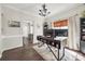 Well-lit home office featuring hardwood floors, modern desk, and neutral walls at 10390 Tintinhull Dr, Indian Land, SC 29707