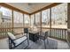 Inviting screened porch featuring comfortable seating and an outdoor table for relaxing or entertaining at 10390 Tintinhull Dr, Indian Land, SC 29707