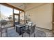 Inviting screened porch featuring comfortable seating and an outdoor table for relaxing or entertaining at 10390 Tintinhull Dr, Indian Land, SC 29707