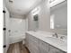 Bathroom featuring a double vanity, large mirrors, and a shower-tub combination at 107 Rutledge Rd, Mount Holly, NC 28120