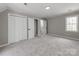 Neutral bedroom with wall to wall carpet, two closets and a window at 107 Rutledge Rd, Mount Holly, NC 28120