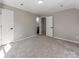 Clean bedroom featuring carpet, and two doorways: one to the closet and one to the bathroom at 107 Rutledge Rd, Mount Holly, NC 28120