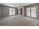 Sunlit bonus room with plush carpeting and multiple windows, providing ample light and a view to the exterior at 107 Rutledge Rd, Mount Holly, NC 28120