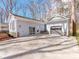 Detached garage with stone accents, concrete driveway, and glass panel door at 107 Rutledge Rd, Mount Holly, NC 28120