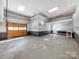 Spacious garage featuring a pegboard work station and concrete flooring at 107 Rutledge Rd, Mount Holly, NC 28120