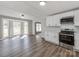 Eat-in kitchen with a bay window, white cabinets, stainless appliances, and durable floors at 107 Rutledge Rd, Mount Holly, NC 28120