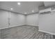 Well-lit basement space boasts modern gray floors, clean walls, and a mini-split AC unit for climate control at 108 Spiral Ln, Shelby, NC 28152