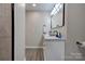 Bathroom featuring double sink vanity with modern fixtures and wood-look flooring at 108 Spiral Ln, Shelby, NC 28152