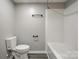 A bathroom featuring a toilet, towel rack, and shower-tub combination with white finishes and wood-look flooring at 108 Spiral Ln, Shelby, NC 28152