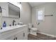 Modern bathroom featuring a vanity with a black faucet and mirror, toilet, and wood-look flooring at 108 Spiral Ln, Shelby, NC 28152