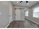 Bedroom with wood-look floors, standard closet, and access via sliding barn door at 108 Spiral Ln, Shelby, NC 28152