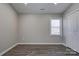 Bedroom with wood-look floors, a window and a double door closet at 108 Spiral Ln, Shelby, NC 28152