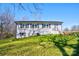 Traditional brick home with manicured lawn, dark shutters, and a side entry with stairs leading to the front door at 108 Spiral Ln, Shelby, NC 28152