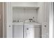 Convenient laundry area with washer and dryer, ample storage space and bright lighting at 108 Spiral Ln, Shelby, NC 28152