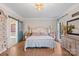 This bedroom features a decorative sliding barn door leading to the ensuite bathroom, hardwood floors, and neutral paint at 1135 Ben Black Rd, Midland, NC 28107