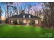 Charming brick home featuring a manicured lawn, black shutters, and dormer windows at 1135 Ben Black Rd, Midland, NC 28107