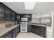 Basement kitchen featuring sleek black cabinets, double oven, and functional countertop space at 1135 Ben Black Rd, Midland, NC 28107