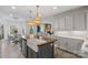 Open kitchen featuring an island and connecting to a dining area and living area at 1135 Ben Black Rd, Midland, NC 28107