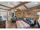 Rustic living room features exposed wood beams, a leather sectional, and unique decor at 1135 Ben Black Rd, Midland, NC 28107