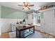 This home office features bead board walls, shelves, a ceiling fan, a window seat, and a wooden desk at 1135 Ben Black Rd, Midland, NC 28107