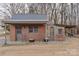 Brick and stone outbuilding with a metal roof and small covered area at 1135 Ben Black Rd, Midland, NC 28107