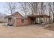 Brick outbuilding featuring a covered area, doors, and stone accents at 1135 Ben Black Rd, Midland, NC 28107