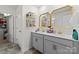 Bright bathroom featuring a dual vanity with gold fixtures and a walk-in closet at 124 Sequoia Forest Dr, Mooresville, NC 28117