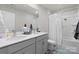 Bathroom with a dual vanity and shower featuring gray cabinetry at 124 Sequoia Forest Dr, Mooresville, NC 28117